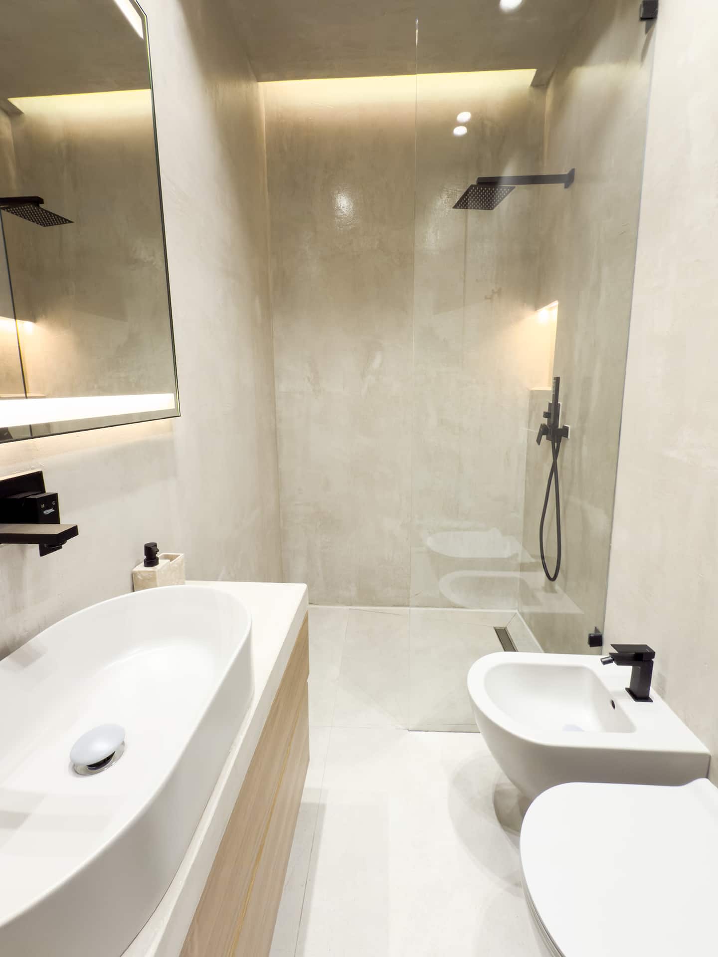 Full bathroom at Villa 4 — walk-in shower and stone finishes.