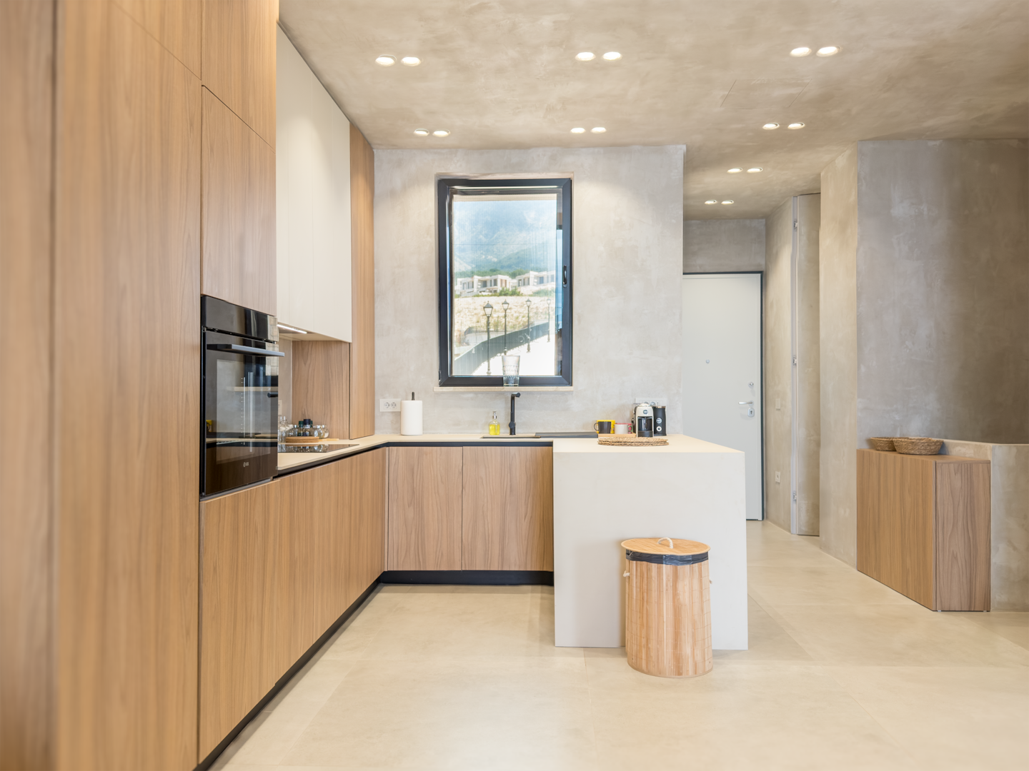 Full kitchen at Villa 4 with oak cabinetry and integrated appliances.