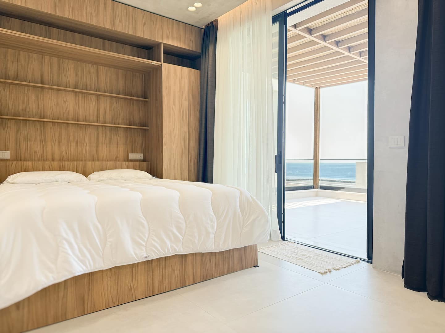 Bedroom 3 at Villa 4 — open-plan room adjacent to the living area.