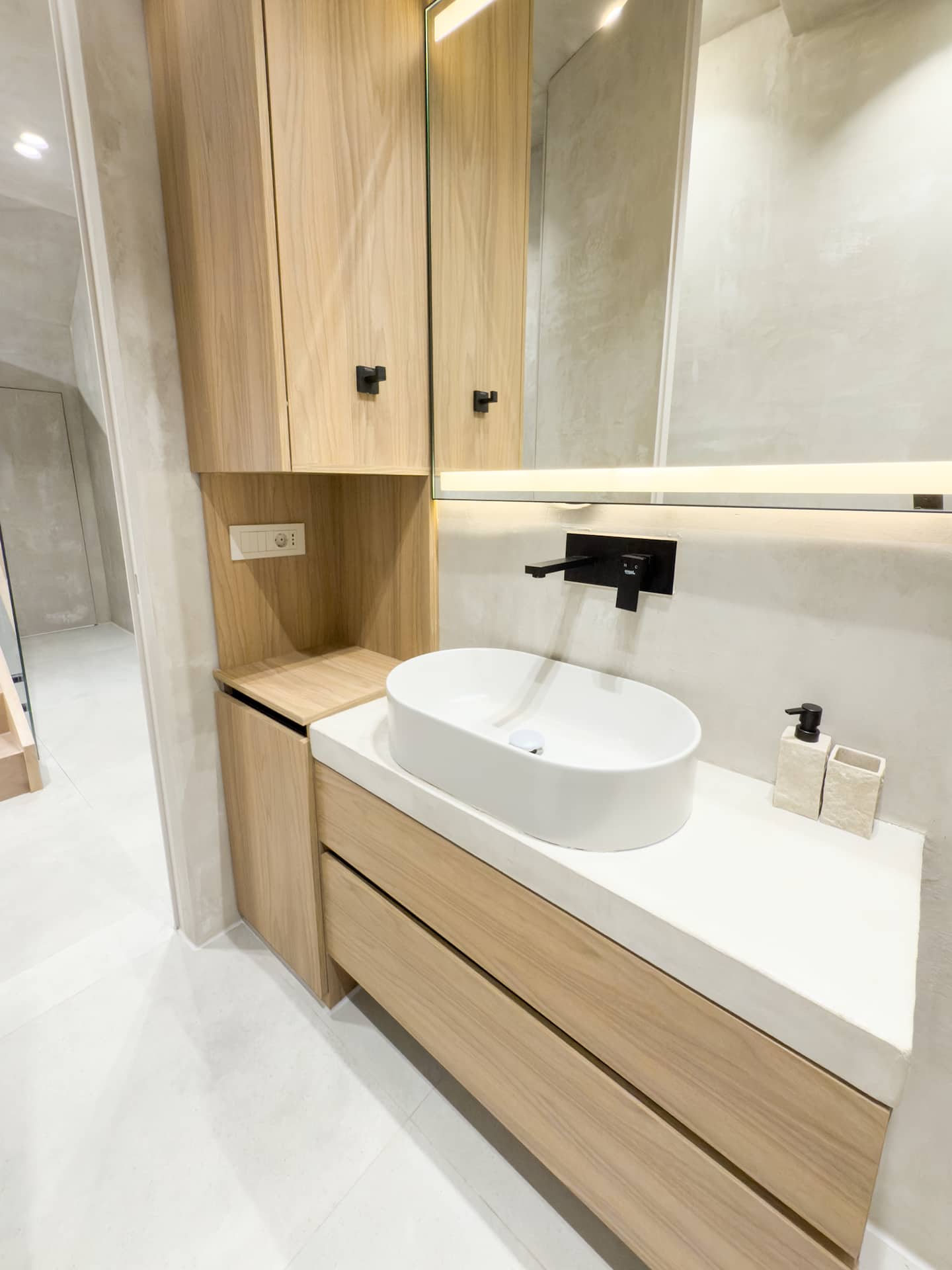 Full bathroom at Villa 4 — walk-in shower and stone finishes.