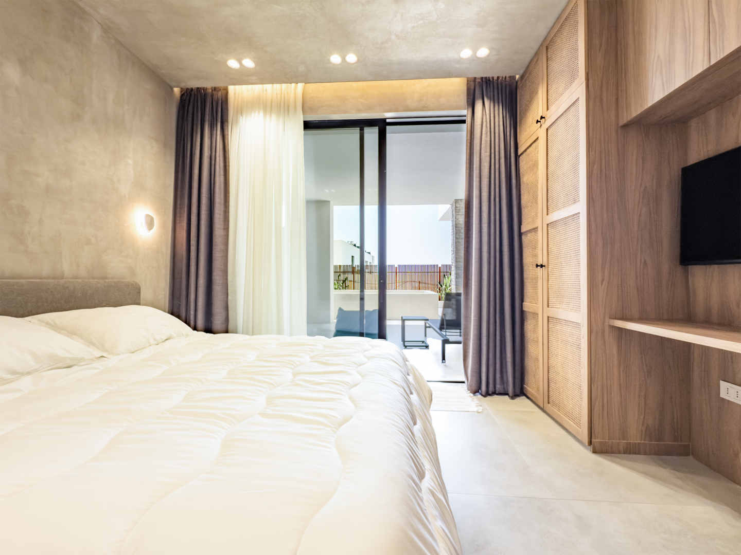 Bedroom 2 at Villa 4 — king bed with calm Mediterranean interiors.