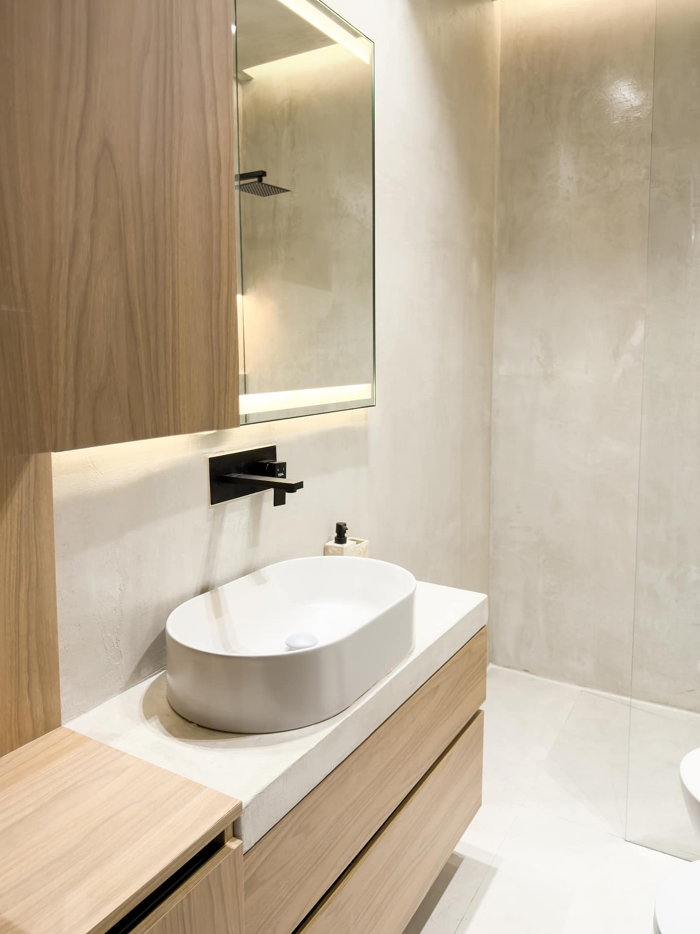 Full bathroom at Villa 4 — walk-in shower and stone finishes.