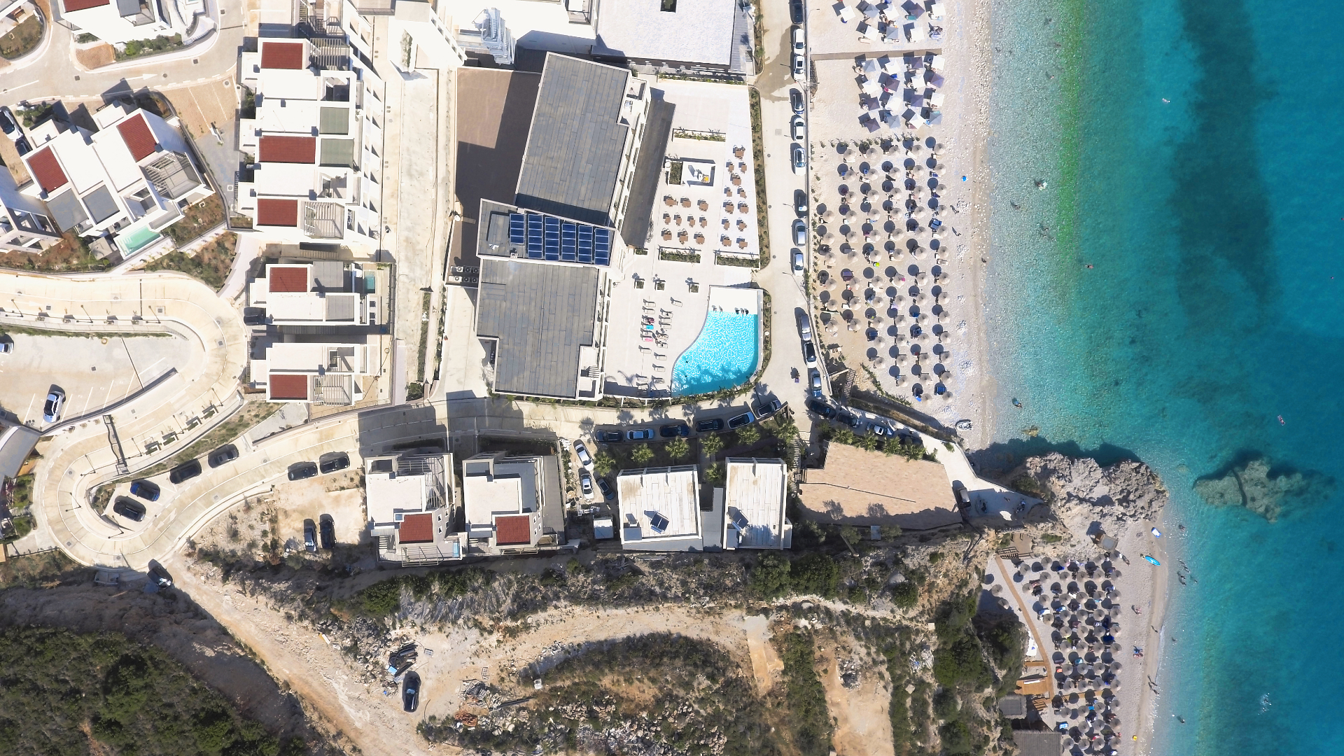 Aerial view of the Drymadhes cove with the Ionian Sea unfolding south of Dhërmi.