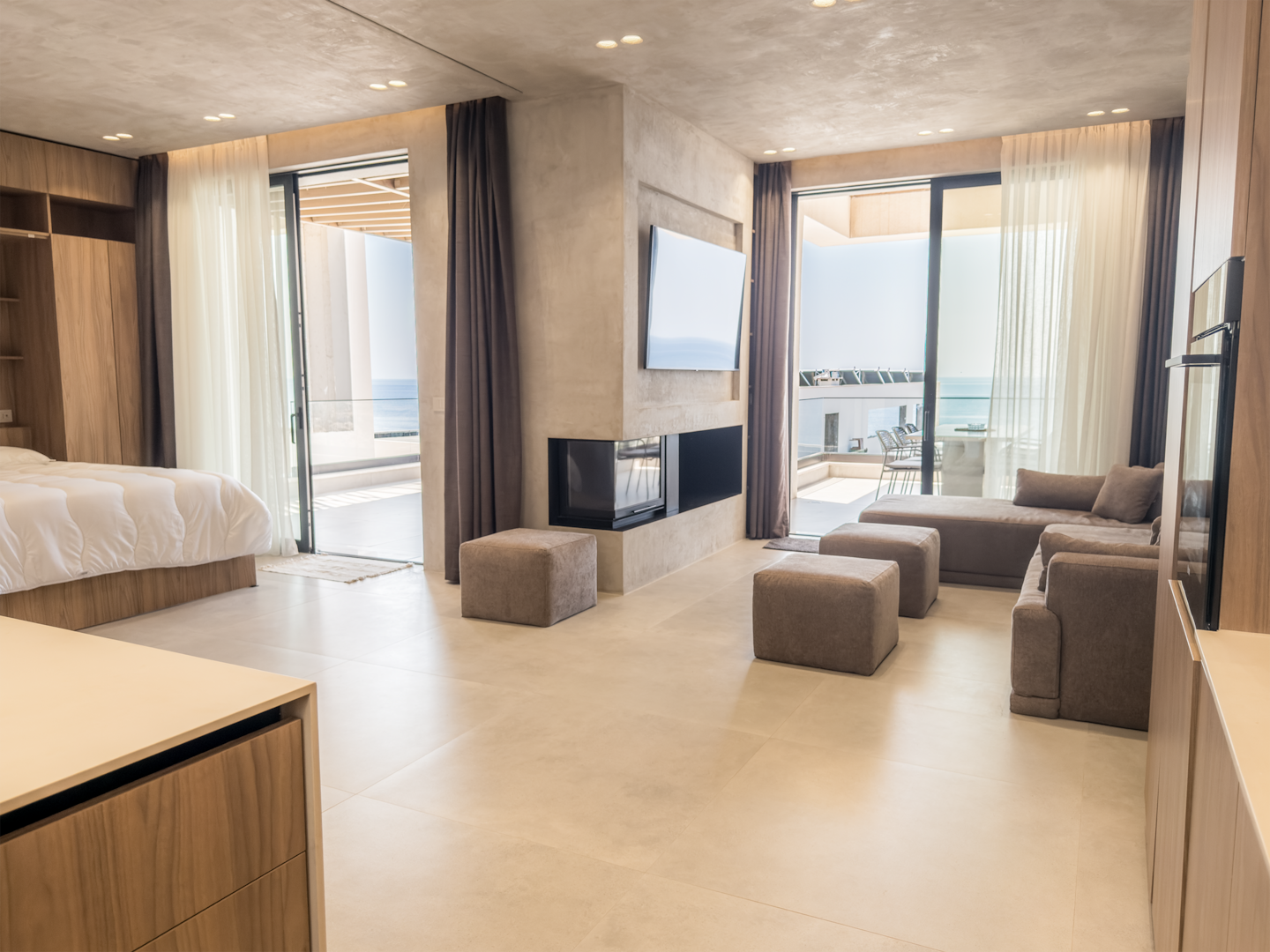 Living room at Villa 4 with fireplace and Ionian sea views.