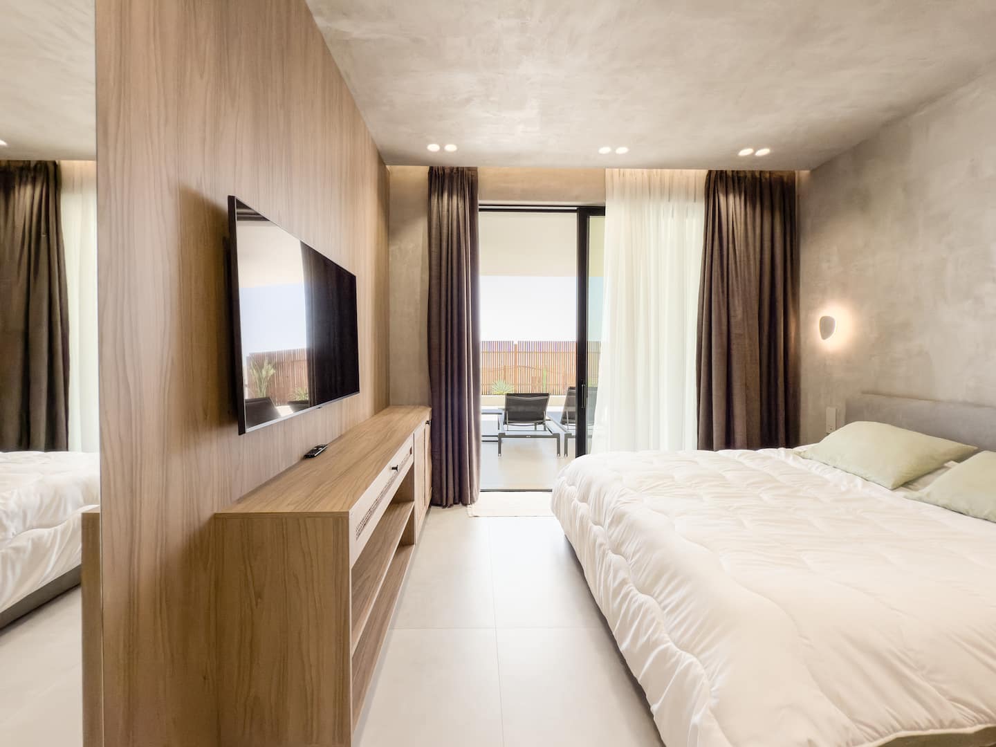 Bedroom 1 at Villa 4 — king bed and terrace access.