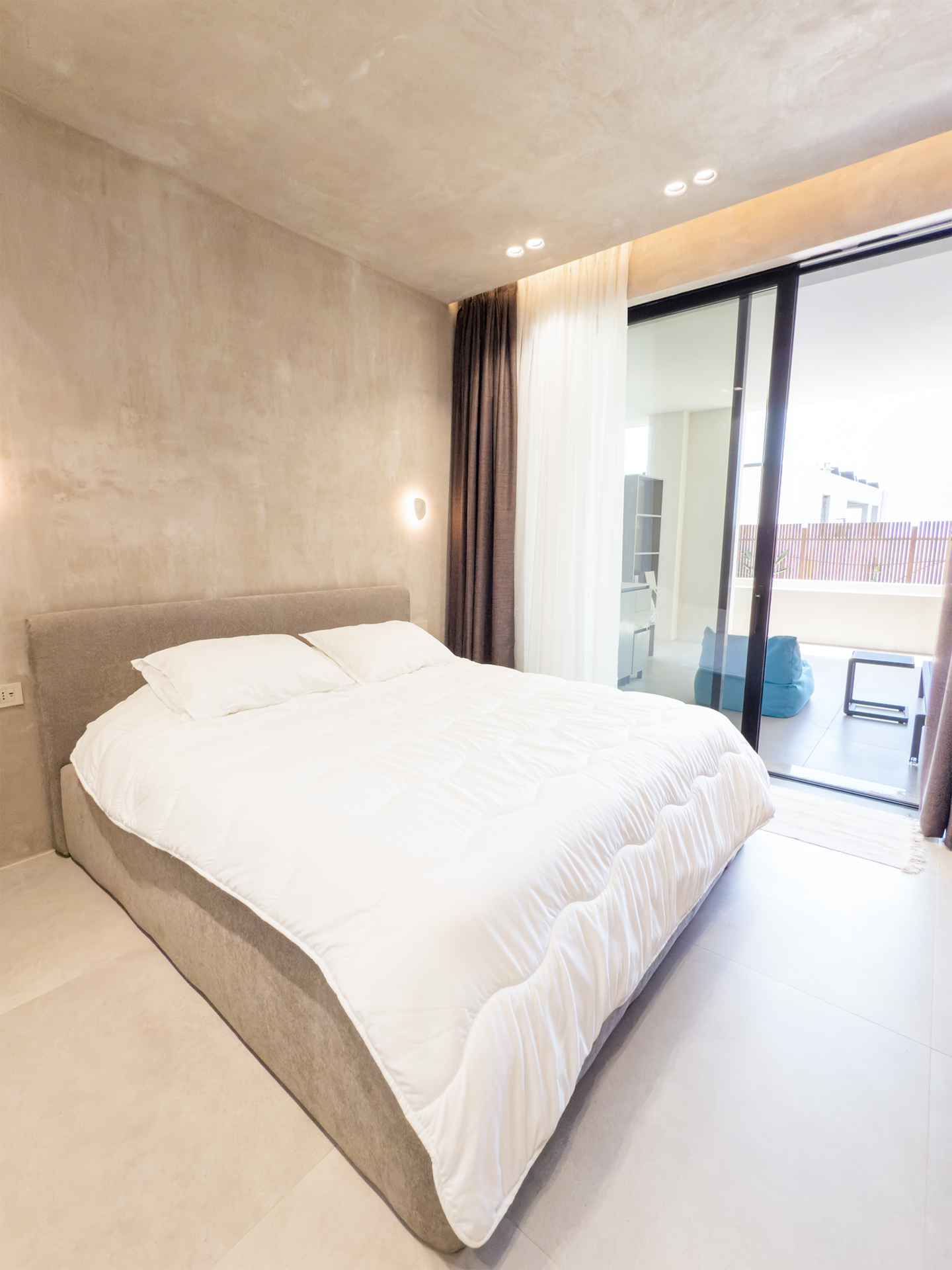 Bedroom 2 at Villa 4 — king bed with calm Mediterranean interiors.