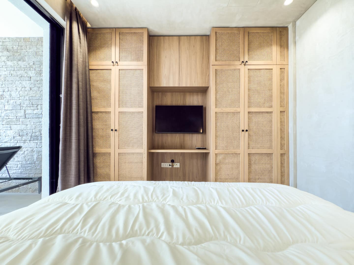Bedroom 2 at Villa 4 — king bed with calm Mediterranean interiors.